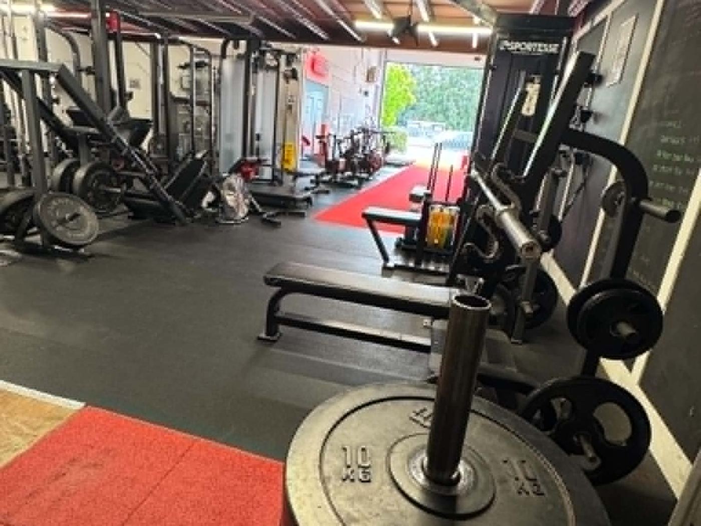 Racks and free weights on the training floor at Amazon24 Fitness